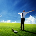 happy young businessman on spring field