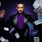 Young brunette magician in stage costume showing card tricks